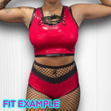 a woman wearing a red top and fishnet stockings