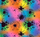 a colorful background with black paint splatters